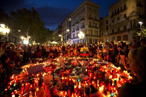 La gente se reúne en un memorial de flores, mensajes y velas a las víctimas en el histórico paseo de Las Ramblas en el mosaico Joan Miro, incrustado en el pavimento donde la camioneta se detuvo después de matar a 13 personas en Barcelona, España. Fotos: Ap
