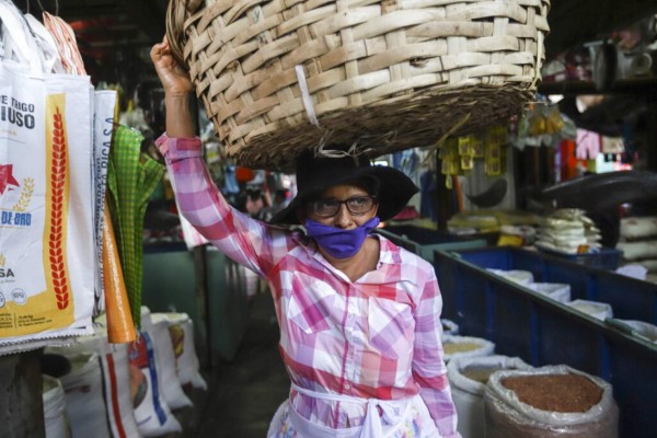 Una mujer intenta vender sus productos en un mercado de Nicaragua, donde a diferencia de los demás países de Centroamérica, no se han ordenado medidas para reducir el número de personas que visitas estos centros de abastecimiento. Foto. AP