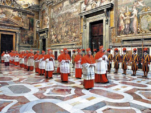 (FILES) This file picture taken on April 18, 2005 shows cardinals entering the Sistine Chapel at the Vatican before the start of the conclave. The conclave triggered by the historic resignation of Benedict XVI will start on March 12, 2013, with the eyes of the world on the 115 men who must nominate one of their own to take his place. AFP PHOTO / FILES / OSSERVATORE ROMANOARTURO MARI RESTRICTED TO EDITORIAL USE ? MANDATORY CREDIT ?AFP PHOTO/OSSERVATORE ROMANO'