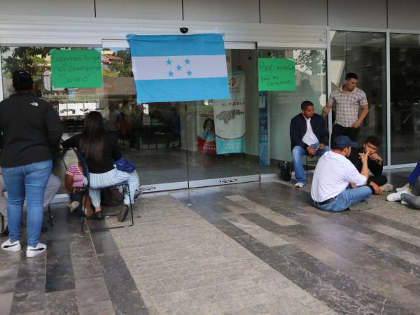 Los empleados del Instituto de la Propiedad (IP), en el Centro Cívico Gubernamental (CCG), en la capital, pusieron la bandera de Honduras en la puerta de entrada a las instalaciones del IP.