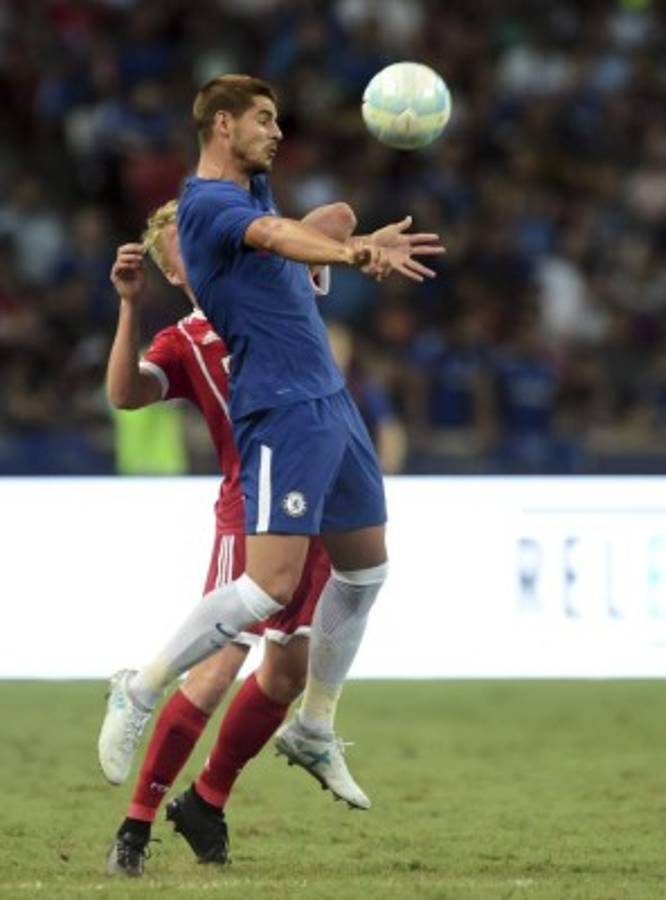 Alvaro Morata of Chelsea vies for the ball with Felix Gotze of Bayern Munich, partially hidden, during the International Champions Cup 2017 match between soccer clubs Bayern Munich from Germany and Chelsea of England, Tuesday, July 25, 2017 in Singapore. (AP Photo/Joseph Nair)