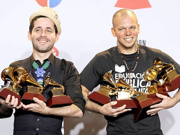 Eduardo Cabra Martinez, also known as Visitante, left, and Rene Perez Joglar, also known as Residente, of musical group Calle 13, pose backstage with their awards at the 12th Annual Latin Grammy Awards on Thursday Nov. 10, 2011 in Las Vegas. (AP Photo/Chris Pizzello)