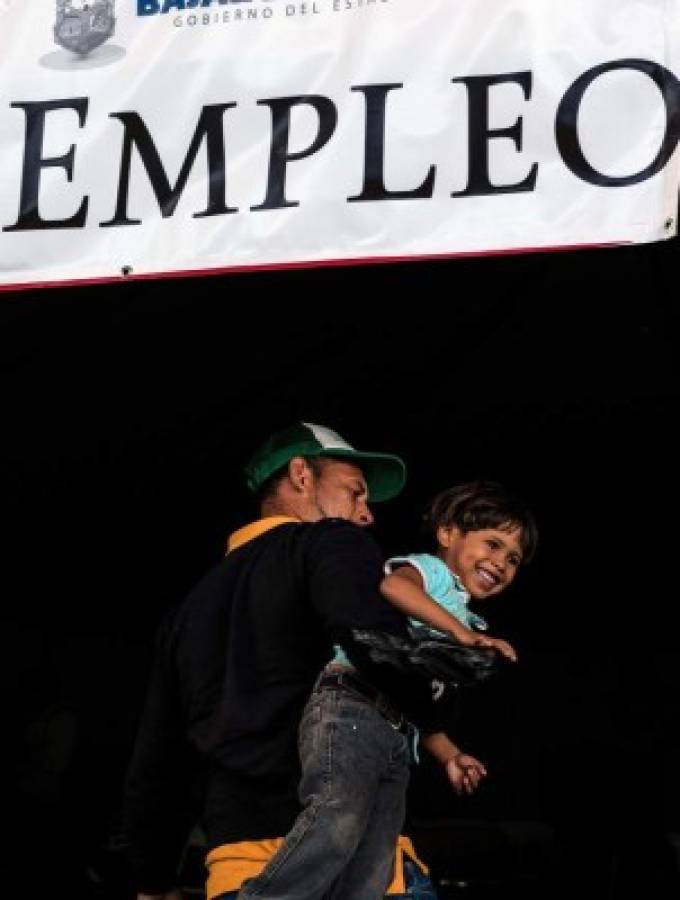 Central American migrants - mostly from Honduras - moving towards the United States in hopes of a better life, are seen at an employment fair near the US-Mexico border in Tijuana, Mexico, on November 19, 2018. - The migrant caravan trekking from Honduras in search of the American dream brings a valuable workforce that Tijuana's industry wants to seize. (Photo by Guillermo Arias / AFP)