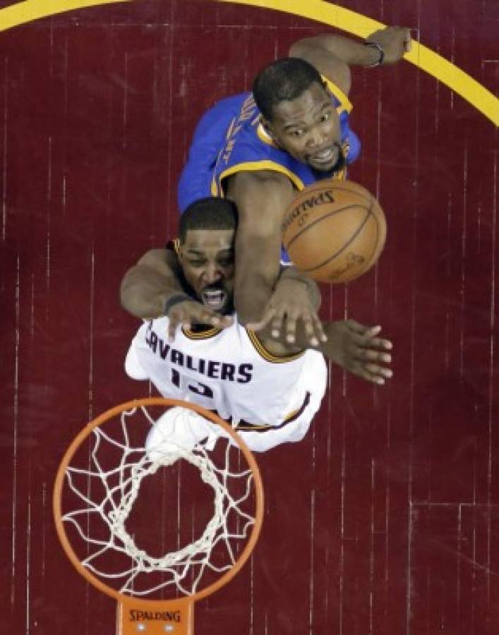 Cleveland Cavaliers' Tristan Thompson, bottom, is stopped by Golden State Warriors' Kevin Durant during the first half of Game 3 of basketball's NBA Finals, Wednesday, June 7, 2017, in Cleveland. The Warriors won 118-113. (AP Photo/Ron Schwane, Pool)