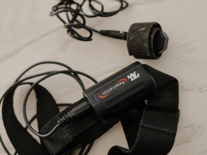 Two sensors Leah Lagos relies on to measure clientsÕ progress: one for the finger to detect changes in blood volume, above, and another for around the abdomen to detect breathing, in New York, March 8, 2026. A proliferation of data from wearable technology is telling people how to optimize their job performance. (Gili Benita/The New York Times)