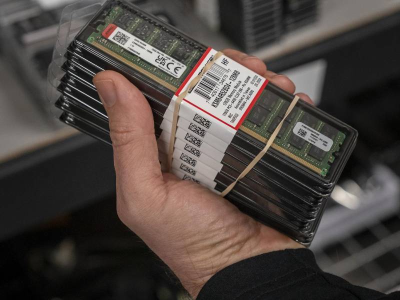 Kelt Reeves, president of Falcon Northwest, holds memory modules that will be installed in customized PCs at the company in Medford, Ore., Jan. 21, 2026. The crunch in memory chips is the latest domino effect from the AI frenzy, which has upended Silicon Valley and lifted the fortunes of AI chip makers like Nvidia. (Loren Elliott/The New York Times)