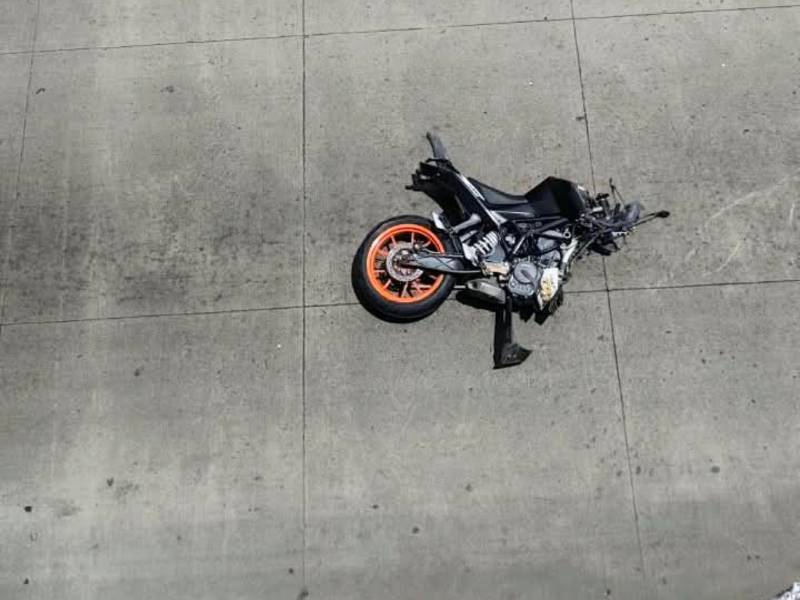 La motocicleta quedó tiradas a varios metros de donde estaba el carro. Las personas grababan todo desde lejos.