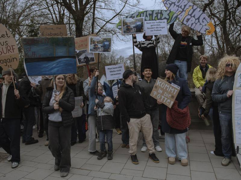 Demonstrators in Munich on Feb. 4, 2026, call for the return of a wave at a creek. For decades, enthusiasts rode the cresting Eisbach creek, but the wave has vanished, prompting arguments about how to restore it.