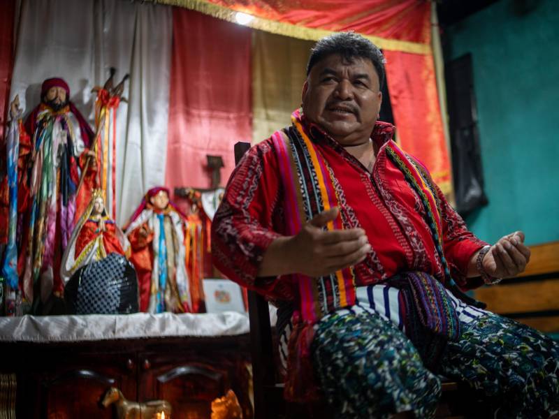 Pie de foto: En la casa de la Cabecera en Santiago Atitlán, a Juan Mendoza Damián, principal autoridad ancestral del pueblo, lo amparan santos católicos. Pero la compleja espiritualidad tz’utujil incluye también la veneración al lago como una madre o a Rilaj Mam, al que los mestizos conocen como Maximón. Foto: Nathalie Quan.