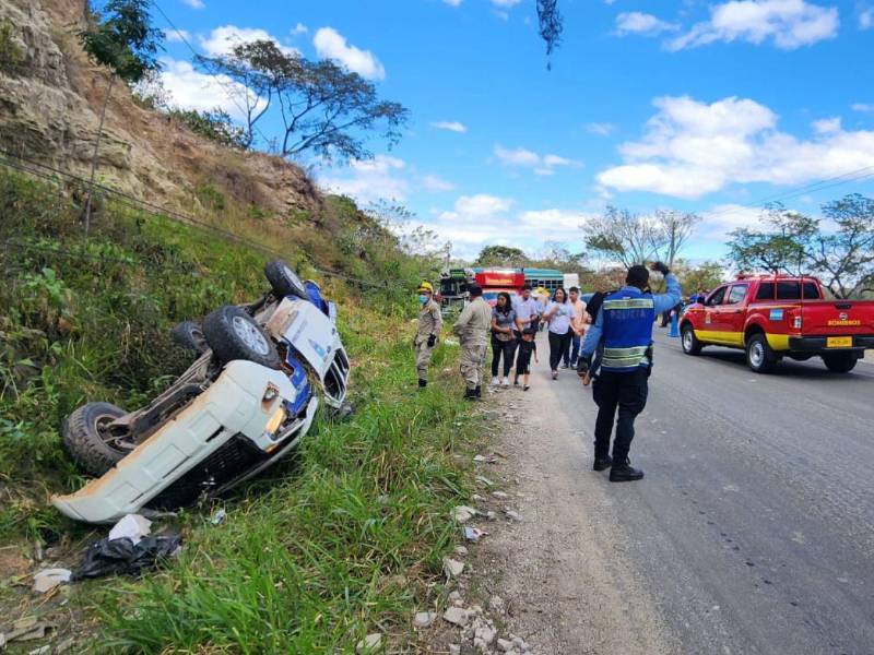 La patrulla en la que se transportaban los agentes policiales se salió de la carretera debido al fuerte impacto y quedó con las llantas hacia arriba.