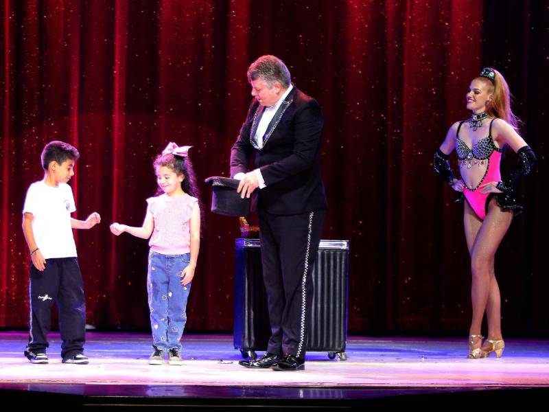 Los niños forman parte del show, aprendiendo a hacer su primer truco de magia.