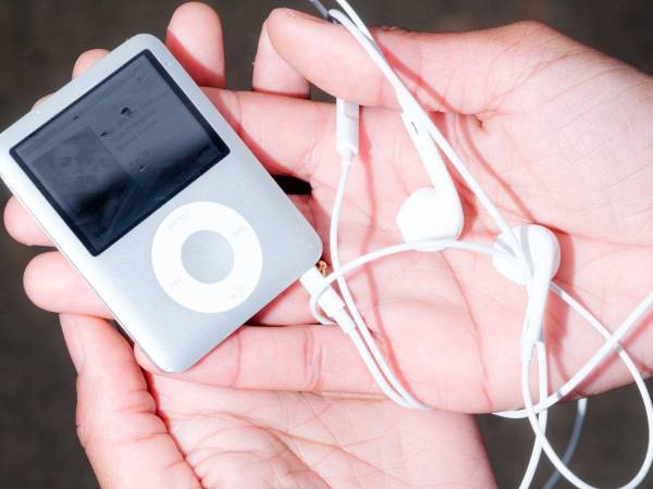 Angeline Richard holds her iPod that she listens to while thrifting and doing other activities in Raleigh, N.C., on Feb. 2, 2026. It’s not exactly going analog, but people looking to move away from streaming say Apple’s old device is a small step away from constantly being online. (Cornell Watson/The New York Times)
