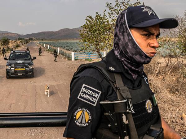 FILE — Police officers passing through a Mexican military checkpoint in Naranjo De Chila, Mexico, the hometown of Nemesio Oseguera Cervantes, on Feb. 24, 2022. Nemesio Oseguera Cervantes, also known as “El Mencho,” was the head of the Jalisco New Generation Cartel and widely regarded as one of the country’s most violent criminal figures. (Daniel Berehulak/The New York Times)