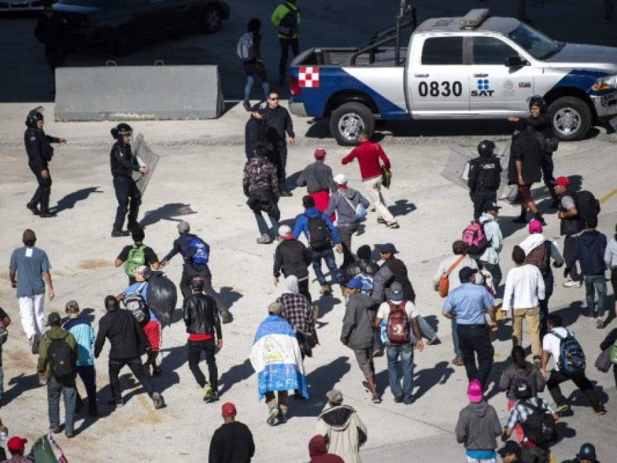 Fotos del momento en el que migrantes de la caravana saltaron valla fronteriza de Estados Unidos, pero fueron detenidos con gases lacrimógenos