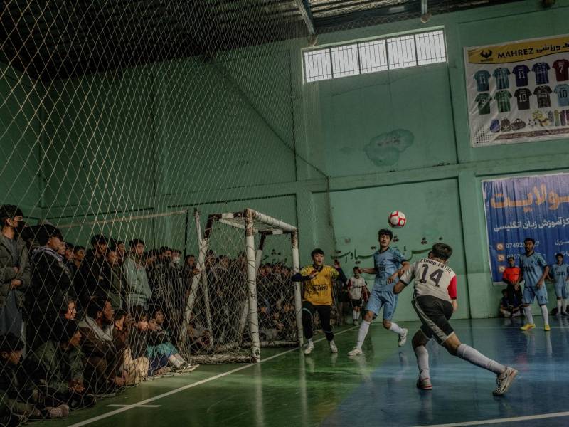 A Bamiyan district league futsal match takes place at a court in Dasht-e-Barchi, Kabul, Afghanistan, Dec. 12, 2025. A triumph in indoor soccer has turned Alireza Ahmadi, 17, and other players from the Hazara minority, long marginalized in Afghanistan, into national heroes. (Tomás Munita/The New York Times)