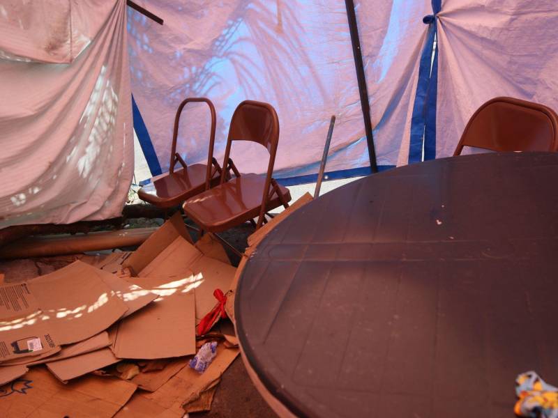 En la acera peatonal, la carpa aún armada de los colectivos, contiene suciedad y desechos dentro de la carpa en la que permanecieron por meses.